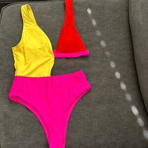 Cutout one piece bathing suit. Vibrant colors- orange, pink and yellow.